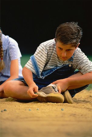 Boy and Girl Playing Marbles Outdoors Stock Photo - Rights-Managed, Code: 700-00060479