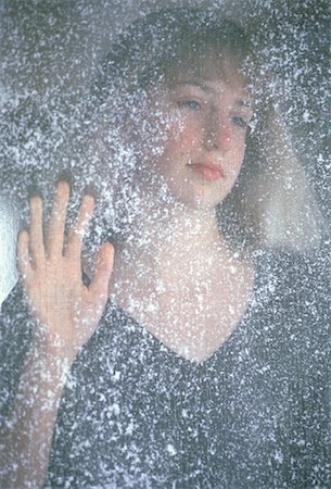 Portrait of Teenage Girl Standing Behind Screen Door with Snow Stock Photo - Rights-Managed, Code: 700-00060539