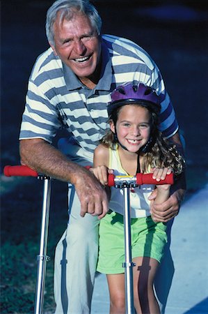 seniors photography girls playing sports - Grandfather and Granddaughter With Scooters Outdoors Stock Photo - Rights-Managed, Code: 700-00060619