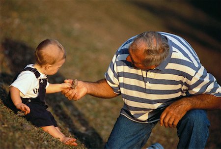 simsearch:700-02199981,k - Grandchild Handing Leaf to Grandfather Outdoors Stock Photo - Rights-Managed, Code: 700-00060632