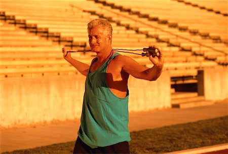 simsearch:700-00060793,k - Mature Man Stretching near Bleachers Stock Photo - Rights-Managed, Code: 700-00060681