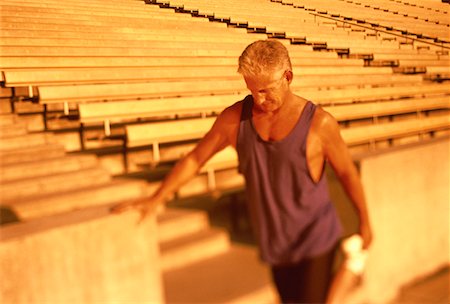 peter griffith - Mature Man Stretching on Bleachers Stock Photo - Rights-Managed, Code: 700-00060732