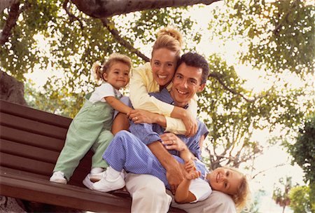 portrait of family on park bench - Portrait of Family Sitting on Park Bench, Embracing Stock Photo - Rights-Managed, Code: 700-00060798