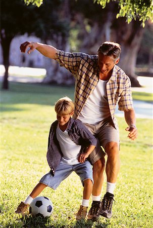 simsearch:700-01494591,k - Father and Son Playing Soccer Outdoors Stock Photo - Rights-Managed, Code: 700-00060799
