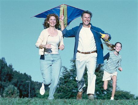 Family Running through Field Flying Kite Stock Photo - Rights-Managed, Code: 700-00060802