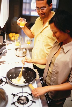 pictures of lady cooking in gas stove - Couple Preparing Food in Kitchen Stock Photo - Rights-Managed, Code: 700-00060812