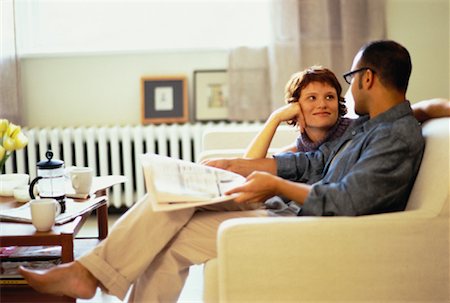 Couple Sitting on Sofa with Newspaper Stock Photo - Rights-Managed, Code: 700-00060938