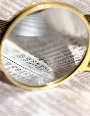 simsearch:600-00049108,k - Close-Up of Magnifying Glass over Stock Listings Stock Photo - Rights-Managed, Code: 700-00061113