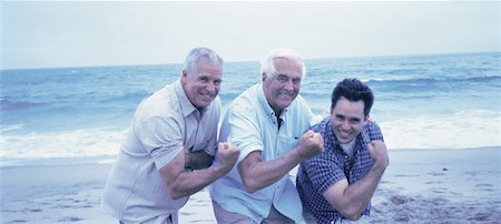 flexing muscles at beach - Portrait of Grandfather, Father And Son Flexing Muscles on Beach Stock Photo - Rights-Managed, Code: 700-00061192