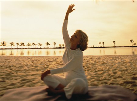 senior women stretching on beach - Mature Woman Practising Yoga on Beach at Sunset, Florida, USA Stock Photo - Rights-Managed, Code: 700-00061213