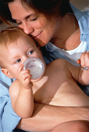 Mother with Baby on Lap Drinking From Bottle Stock Photo - Rights-Managed, Code: 700-00061274