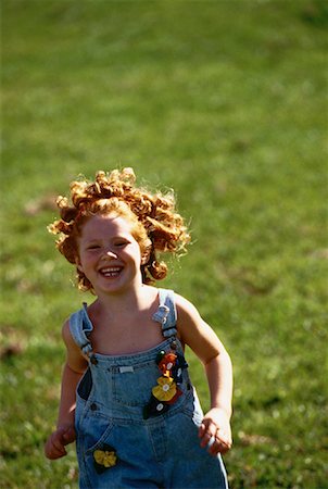 Girl Walking through Field Smiling Stock Photo - Rights-Managed, Code: 700-00061359