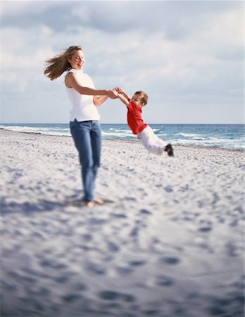 Mother Swinging Son by Arms on Beach Stock Photo - Rights-Managed, Code: 700-00061461