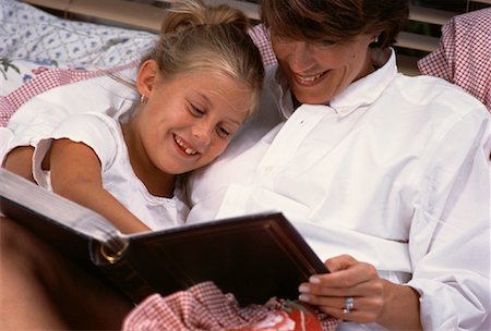 family photos in album - Mother and Daughter Looking at Photo Album Stock Photo - Rights-Managed, Code: 700-00061526