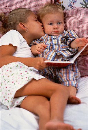 simsearch:700-00047419,k - Girl Kissing Young Boy on Cheek With Book Stock Photo - Rights-Managed, Code: 700-00061528