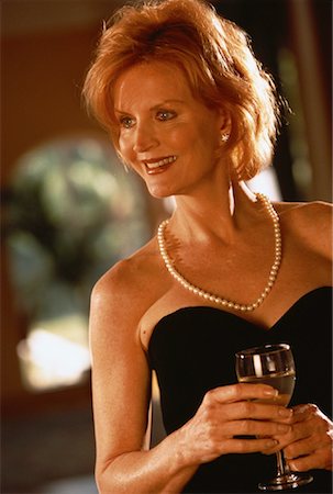 Mature Woman in Formal Wear Holding Glass of Wine Stock Photo - Rights-Managed, Code: 700-00061536