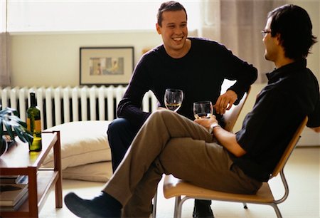 Male Couple Sitting on Chairs Holding Glasses of Wine Stock Photo - Rights-Managed, Code: 700-00061784