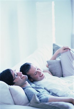 Male Couple Relaxing on Sofa Smiling Stock Photo - Rights-Managed, Code: 700-00061788