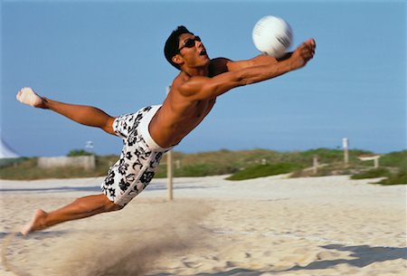 diving (not water) - Man Diving to Hit Volley Ball on Beach Foto de stock - Con derechos protegidos, Código: 700-00061902
