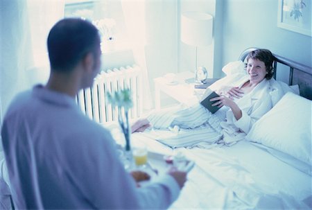 ron fehling bedroom - Man Bringing Breakfast to Woman In Bed with Book Stock Photo - Rights-Managed, Code: 700-00062052