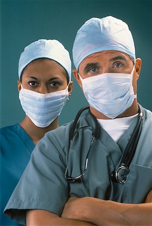Portrait of Male and Female Surgeons Wearing Surgical Masks Stock Photo - Rights-Managed, Code: 700-00062078
