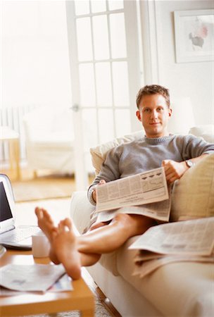 Portrait of Man Sitting on Sofa Holding Newspaper Stock Photo - Rights-Managed, Code: 700-00062135