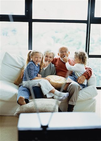 senior man watching tv family - Grandparents and Granddaughters Sitting on Sofa, Watching TV Stock Photo - Rights-Managed, Code: 700-00062484