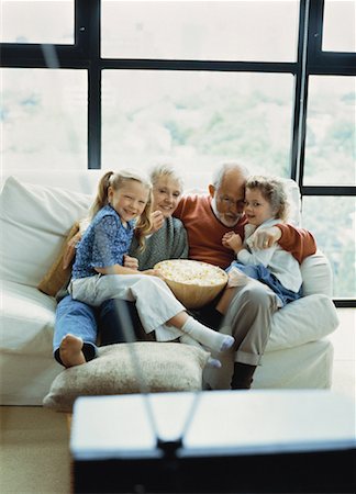 senior man watching tv family - Grandparents and Granddaughters Sitting on Sofa, Watching TV Stock Photo - Rights-Managed, Code: 700-00062483