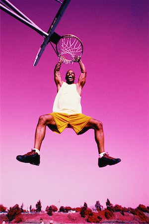 Man Hanging from Rim of Basketball Net, Yelling Stock Photo - Rights-Managed, Code: 700-00062506