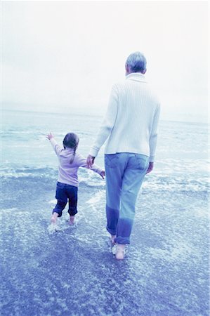 simsearch:700-00062714,k - Back View of Grandmother and Granddaughter Walking in Surf Stock Photo - Rights-Managed, Code: 700-00062710