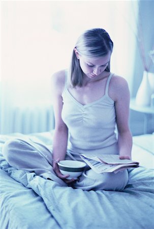 simsearch:700-00062758,k - Woman Sitting on Bed Reading Newspaper, Holding Bowl Stock Photo - Rights-Managed, Code: 700-00062756