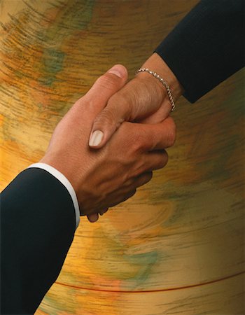 Close-Up of Business Handshake With Spinning Globe Foto de stock - Con derechos protegidos, Código: 700-00062986