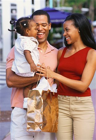 pictures of black people holding shopping bags - Mother Holding Shopping Bags Father Carrying Daughter Outdoors Stock Photo - Rights-Managed, Code: 700-00063027