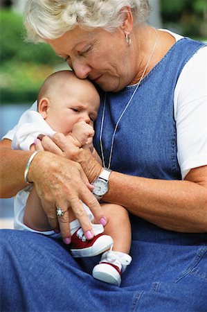 simsearch:700-02199981,k - Grandmother Holding Grandchild Outdoors Stock Photo - Rights-Managed, Code: 700-00063031