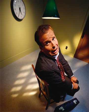 simsearch:700-00695821,k - Worried Businessman Sitting in Chair Under Lamp Stock Photo - Rights-Managed, Code: 700-00063536