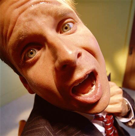 Close-Up of Worried Businessman Loosening Tie Stock Photo - Rights-Managed, Code: 700-00063533
