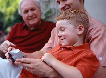 father holding son in lap - Grandfather, Father and Son Looking at Camera Stock Photo - Rights-Managed, Code: 700-00063560