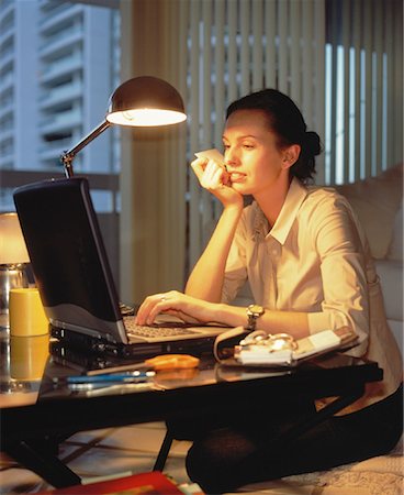 Woman Sitting at Desk, Using Laptop Computer Stock Photo - Rights-Managed, Code: 700-00063826