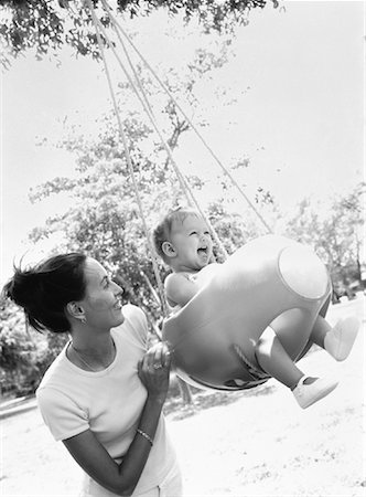 Mother Pushing Daughter in Swing Fotografie stock - Rights-Managed, Codice: 700-00063836