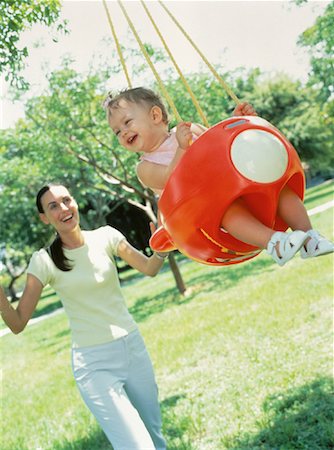 Mother Pushing Daughter in Swing Fotografie stock - Rights-Managed, Codice: 700-00063837