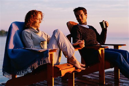 Couple Sitting in Chairs on Dock Holding Hands Stock Photo - Rights-Managed, Code: 700-00074049