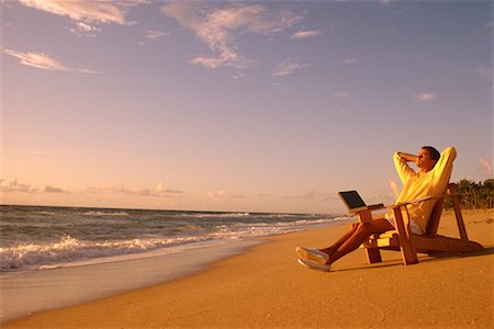 Man Relaxing in Adirondack Chair On Beach with Laptop Computer Stock Photo - Rights-Managed, Code: 700-00074648