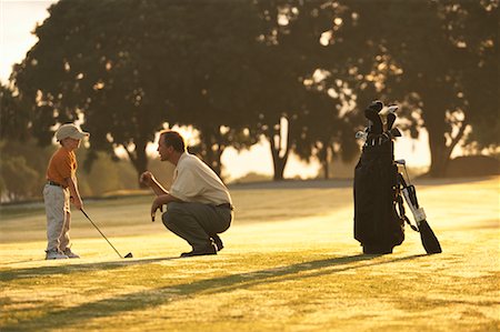 Father Giving Son Golfing Lessons Stock Photo - Rights-Managed, Code: 700-00074655