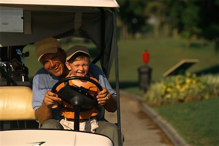 Father and Son Driving Golf Cart Stock Photo - Rights-Managed, Code: 700-00074652