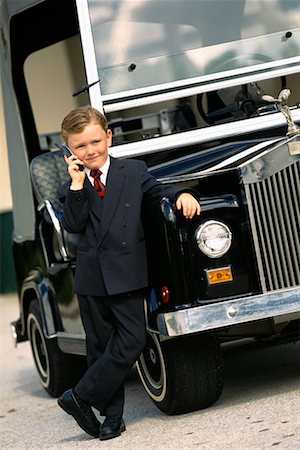 simsearch:700-00012677,k - Portrait of Boy Dressed as Businessman, Leaning on Luxury Golf Cart, Using Cell Phone Stock Photo - Rights-Managed, Code: 700-00074660