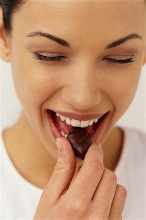 Portrait of Woman Eating Chocolate Stock Photo - Rights-Managed, Code: 700-00074682