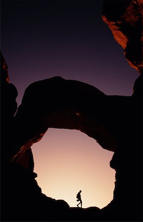 simsearch:700-00024815,k - Silhouette de la personne randonnée sous l'arche au coucher du soleil Arches National Park, Utah, Etats-Unis Photographie de stock - Rights-Managed, Code: 700-00074720
