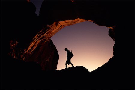 simsearch:700-00024815,k - Silhouette de la personne randonnée sous l'arche au coucher du soleil Arches National Park, Utah, Etats-Unis Photographie de stock - Rights-Managed, Code: 700-00074721