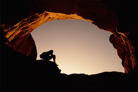 simsearch:700-00024815,k - Silhouette de personne assis sous l'arche au coucher du soleil Arches National Park, Utah, Etats-Unis Photographie de stock - Rights-Managed, Code: 700-00074722