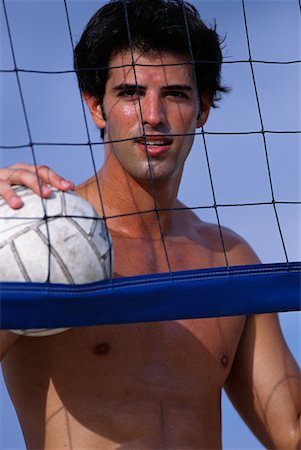 Portrait of Man Leaning on Net Holding Volleyball Outdoors Stock Photo - Rights-Managed, Code: 700-00074748
